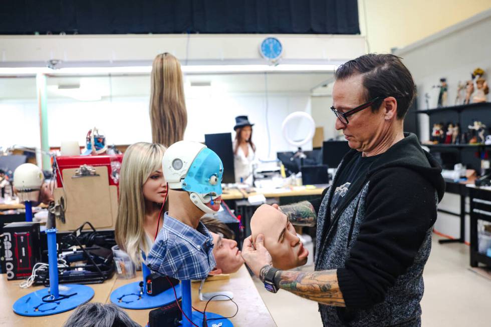 Founder Matt McMullen places a face on a robot at the workshop for Realbotix, a company that ma ...