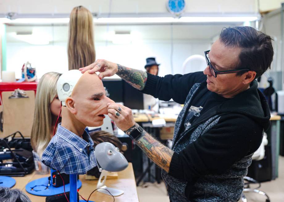 Founder Matt McMullen places a face on a robot at the workshop for Realbotix, a company that ma ...