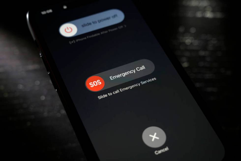 A button used to contact emergency services is seen on a mobile phone, Thursday, April 18, 2024 ...
