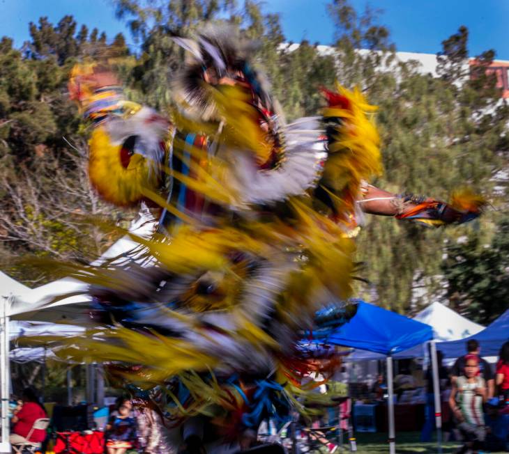 A dancer moves about the grounds while performing for the crowd during the Powwow for the Plane ...