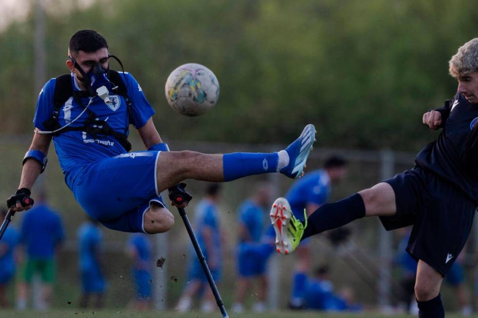 Wearing a device that measures his energy consumption, the Israel Amputee Football Team player, ...