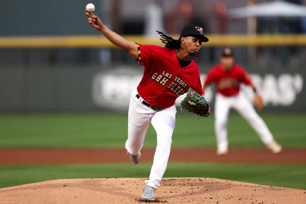 Las Vegas Aviators pitcher Osvaldo Bido, wearing a Las Vegas Gamblers jersey, throws to the Tac ...