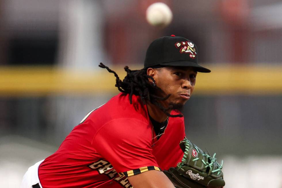 Las Vegas Aviators pitcher Osvaldo Bido, wearing a Las Vegas Gamblers jersey, throws to the Tac ...