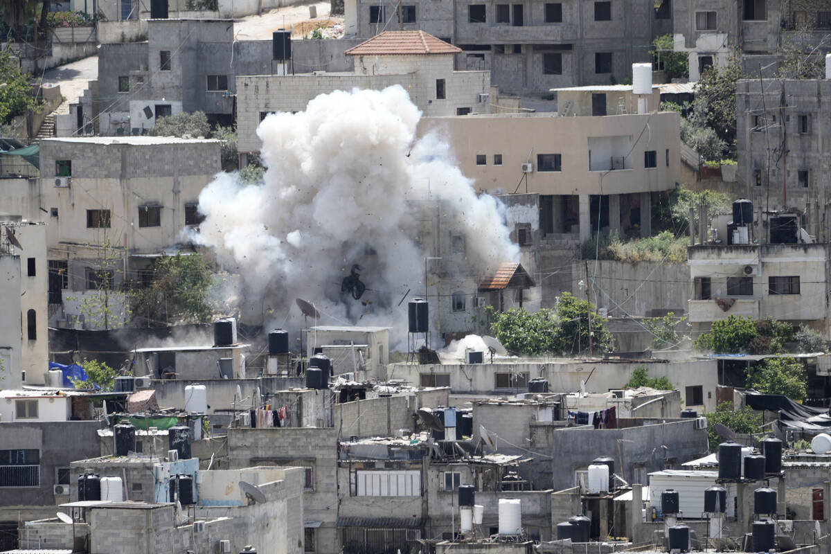 Smoke rises from an explosion during an Israeli military raid in the Nur Shams refugee camp, ne ...