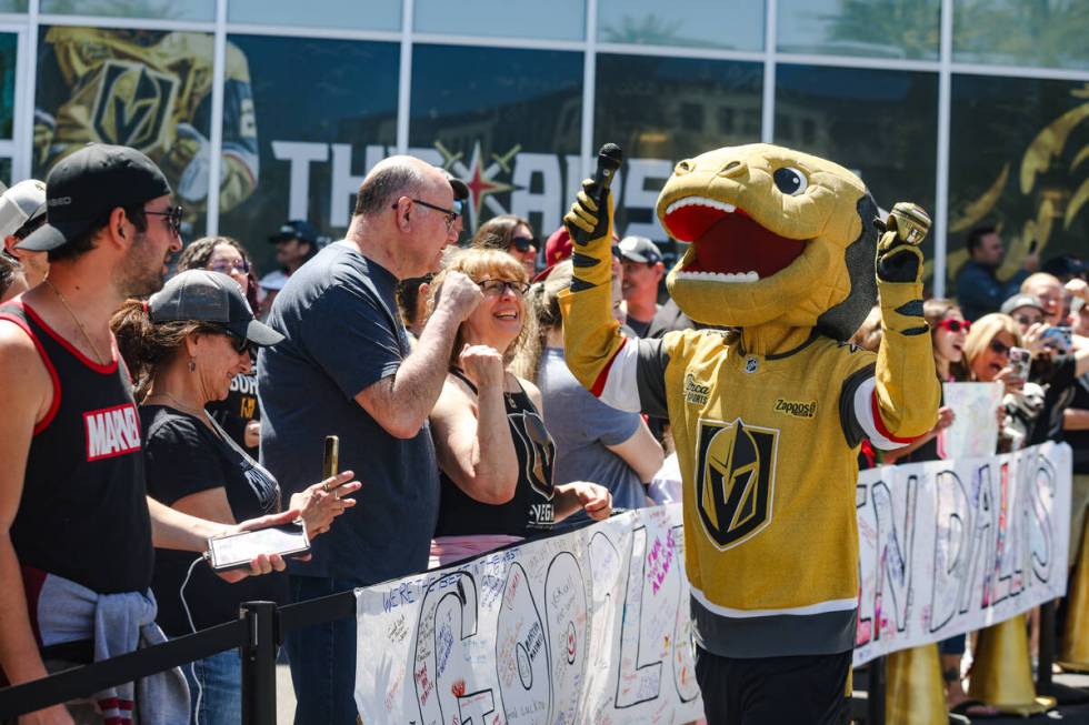 Golden Knights mascot Chance rallies the crowd as they wait for Golden Knights players to depar ...