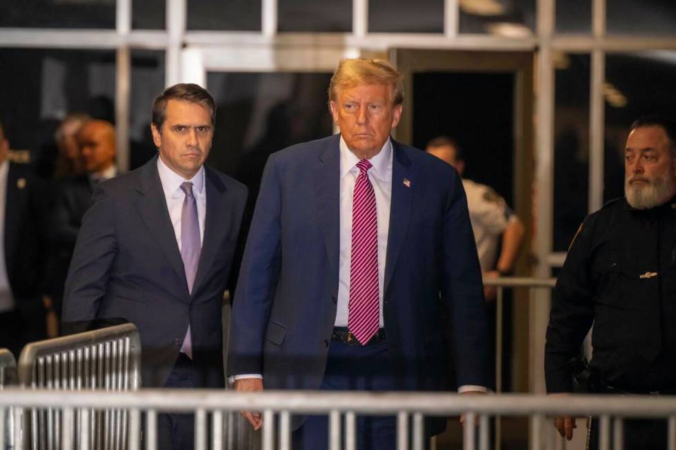 Former President Donald Trump, followed by his attorney Todd Blanche, left, exits the courtroom ...