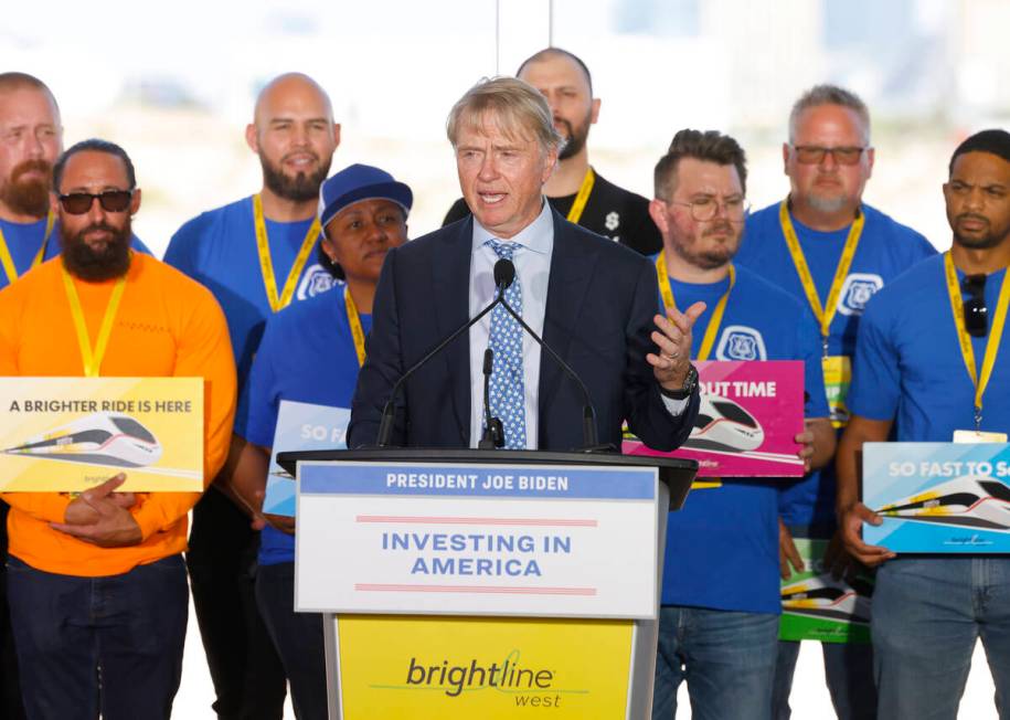 Brightline founder and chairman Wes Edens, flanked by union workers, speaks before the groundbr ...