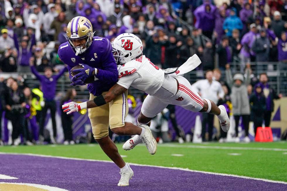 FILE - Washington wide receiver Rome Odunze (1) makes a catch for a touchdown against Utah corn ...