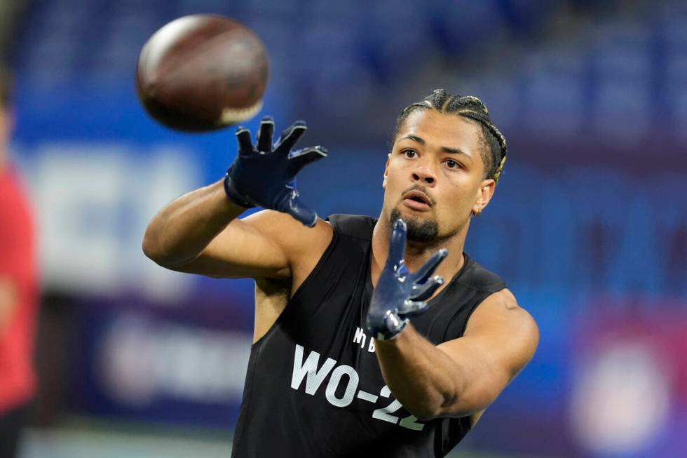 Washington wide receiver Rome Odunze runs a drill at the NFL football scouting combine, Saturda ...