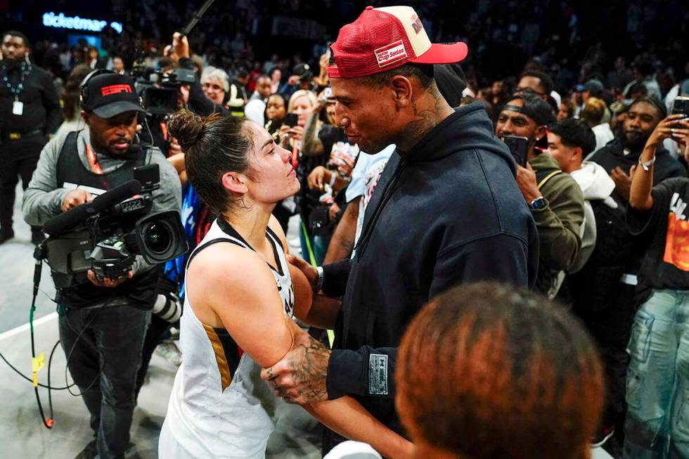 Las Vegas Aces' Kelsey Plum, left, talks with New York Giants Darren Waller after Game 4 of a W ...