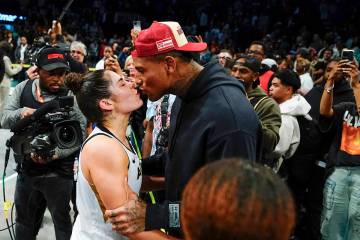 Las Vegas Aces' Kelsey Plum, left, kisses New York Giants' Darren Waller after Game 4 of a WNBA ...