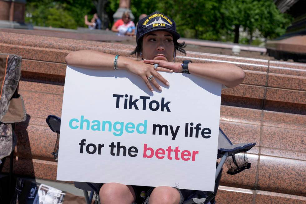 A TikTok content creator, sits outside the U.S. Capitol, Tuesday, April 23, 2024, in Washington ...