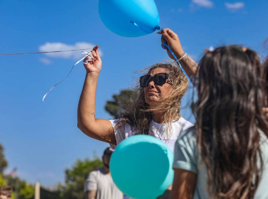 Regina Lacerda, mother of Tabatha Tozzi, releases a balloon in honor of her daughter at a celeb ...