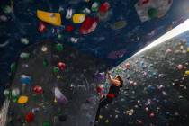 Marijke McCandless free climbs a rock wall following a panel about outdoor recreational access, ...
