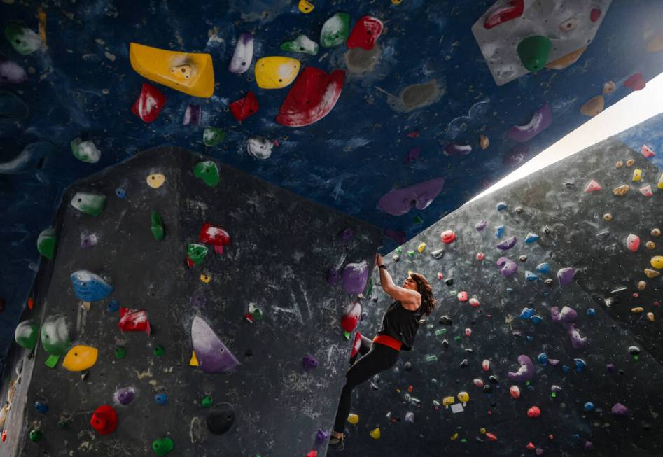 Marijke McCandless free climbs a rock wall following a panel about outdoor recreational access, ...