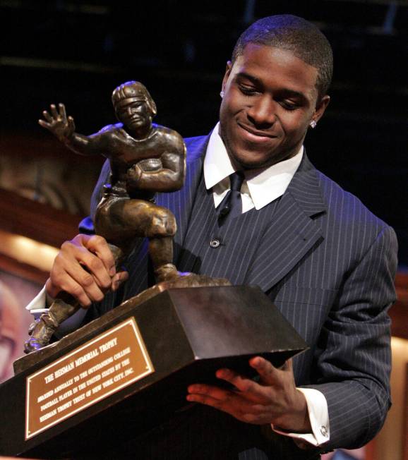 Southern California tailback Reggie Bush picks up the Heisman Trophy after being announced as t ...