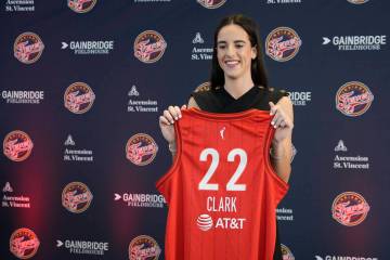 Indiana Fever's Caitlin Clark holds her jersey following a WNBA basketball news conference, Wed ...