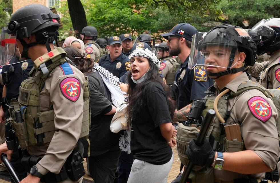 A woman is arrested at a pro-Palestinian protest at the University of Texas, Wednesday April 24 ...