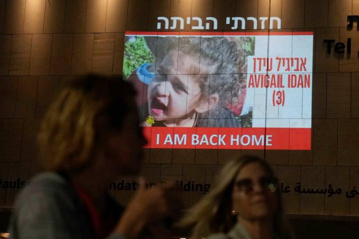 FILE - People walk past an image of 4-year-old Abigail Edan, a hostage held by Hamas, projected ...
