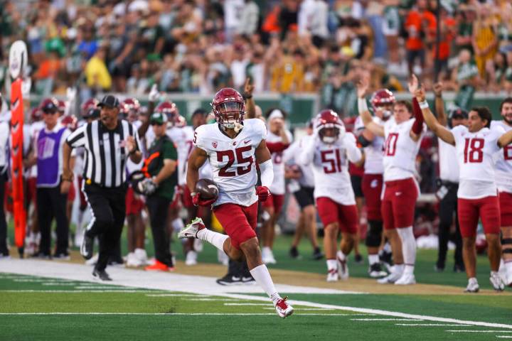Washington State safety Jaden Hicks returns an interception for a touchdown while playing Color ...