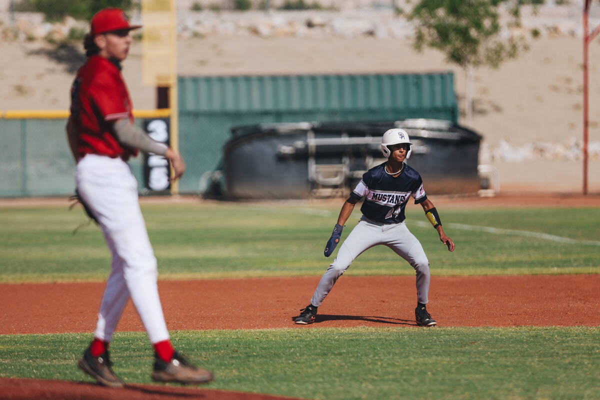 Shadow Ridge outfielder Andrew Torres (24) eyes the ball from first base during a high school b ...
