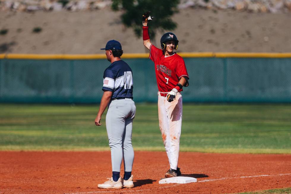 Las Vegas’ Mickey Martinez (7) signals to his teammates after making it to first base du ...