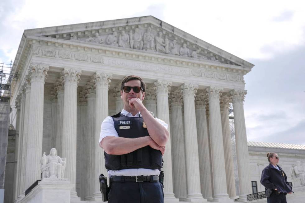 The Supreme Court is seen during a protest as the justices prepare to hear arguments over wheth ...