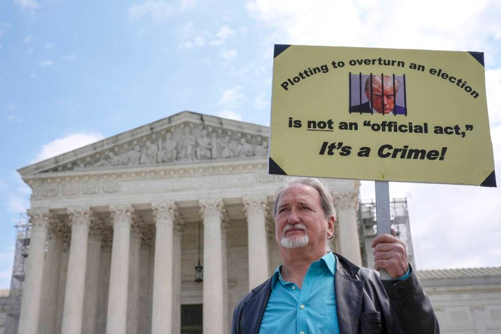 A demonstrator stands outside the Supreme Court as the justices prepare to hear arguments over ...