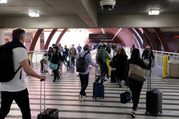 Travelers walk into Harry Reid International Airport on Monday, Feb. 12, 2024, in Las Vegas. (K ...