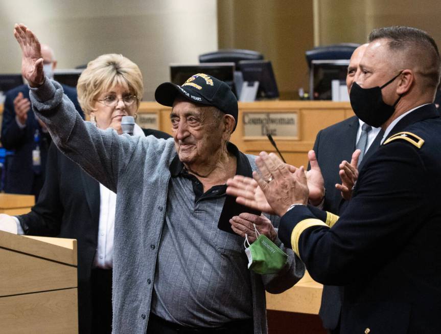 A 98-year-old World War II veteran, Onofrio ÒNo-NoÓ Zicari, left, acknowledges the cr ...