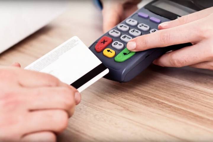 Skimming involves stealing credit card information by putting an illegal card reading device on ...