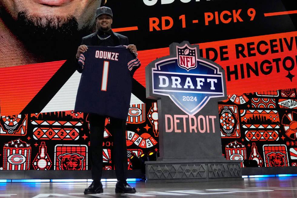 Washington wide receiver Rome Odunze poses after being chosen by the Chicago Bears with the nin ...