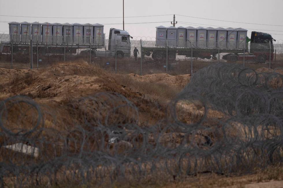 Trucks, carrying humanitarian supplies for the Gaza Strip, wait in line on the Egyptian side, a ...