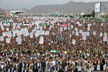 Thousands of Houthi supporters take part at a rally against the U.S. and Israel and to support ...