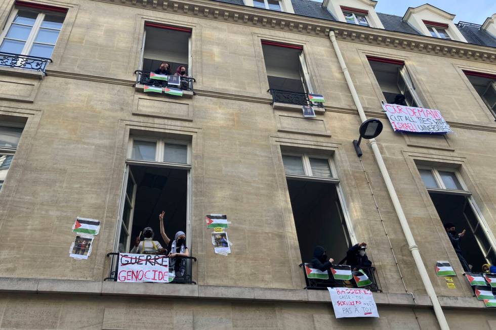 Students blocking the Sciences Po university look out Friday, April 26, 2024 in Paris. (AP Phot ...