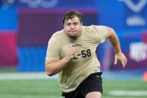Oregon offensive lineman Jackson Powers-Johnson runs a drill at the NFL football scouting combi ...