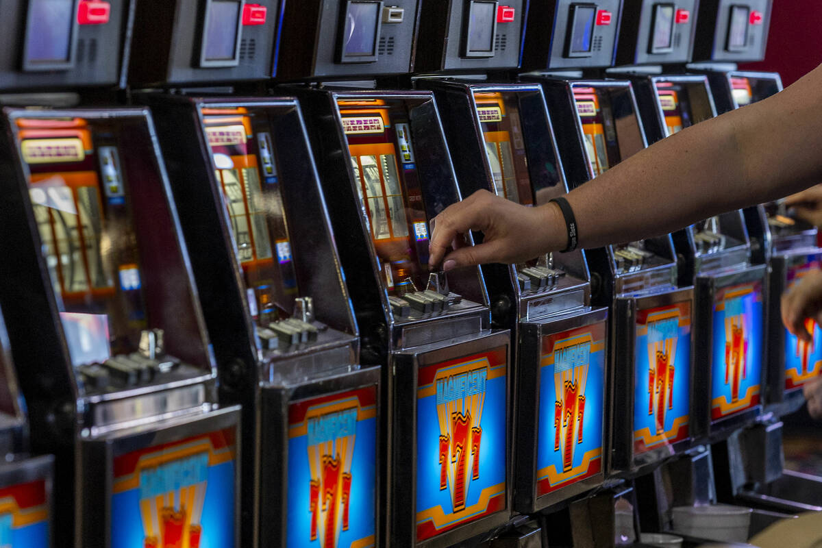 A player inserts a coin into a machine within the revamped slots area called Slots A Fun which ...