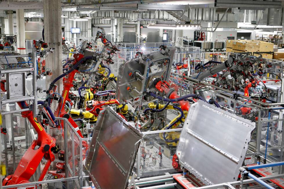 Robots work in many areas of the Tesla Gigafactory, east of Reno, Nev., on Tuesday, Dec. 4, 201 ...