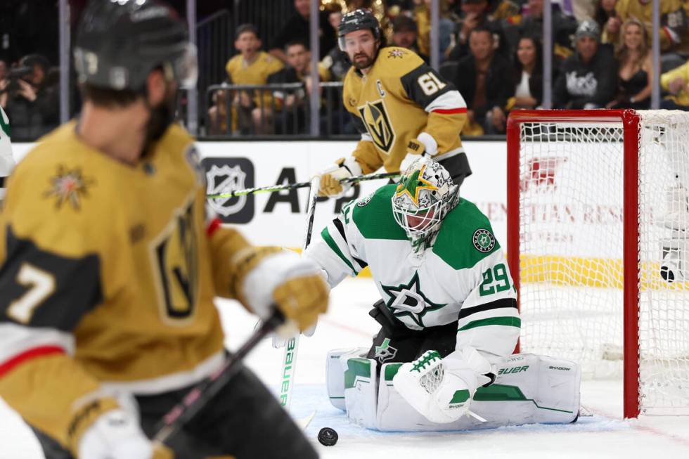 Stars goaltender Jake Oettinger (29) saves the puck while Golden Knights defenseman Alex Pietra ...