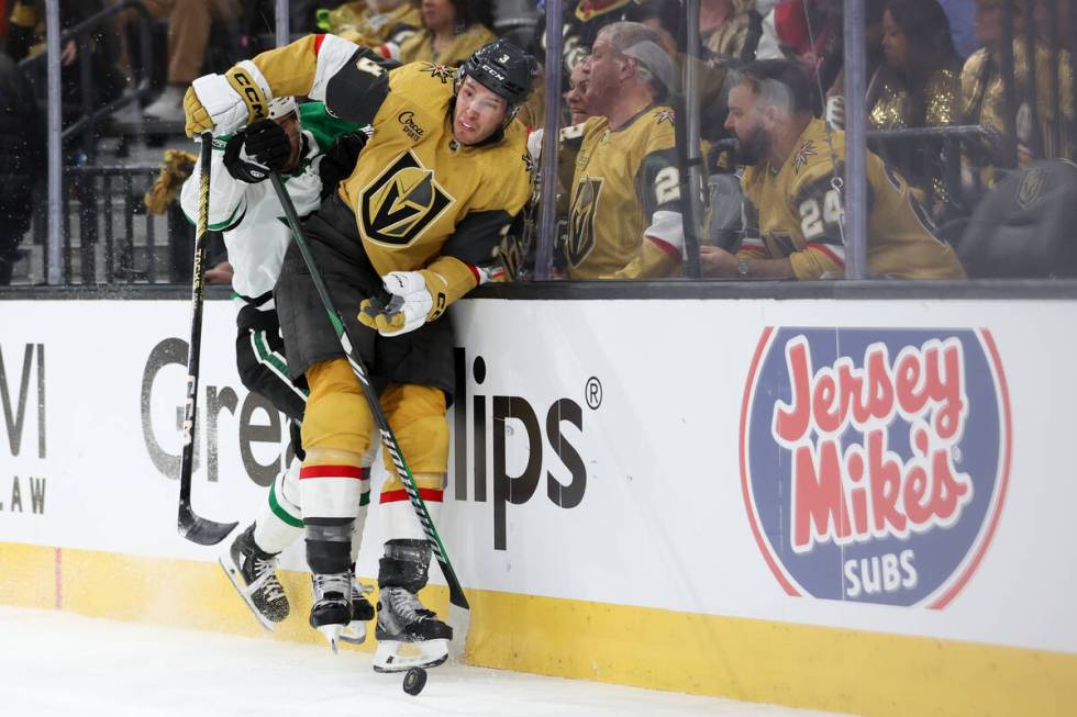 Golden Knights defenseman Brayden McNabb (3) is checked into the boards by Stars center Sam Ste ...