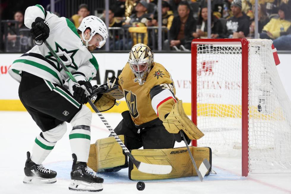 Golden Knights goaltender Logan Thompson (36) saves the puck against Stars center Sam Steel (18 ...