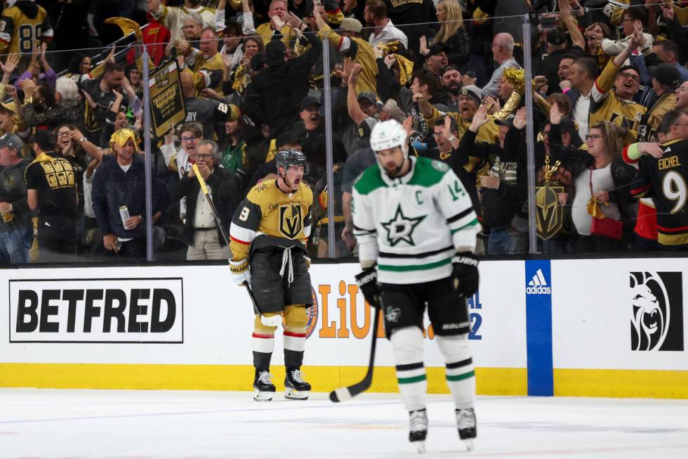 Golden Knights center Jack Eichel (9) celebrates after scoring while Stars left wing Jamie Benn ...