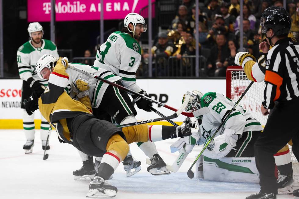 Stars defenseman Thomas Harley (55) throws down Golden Knights center Tomas Hertl (48) to pull ...