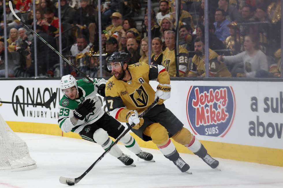 Golden Knights defenseman Alex Pietrangelo (7) skates with the puck against Stars center Wyatt ...