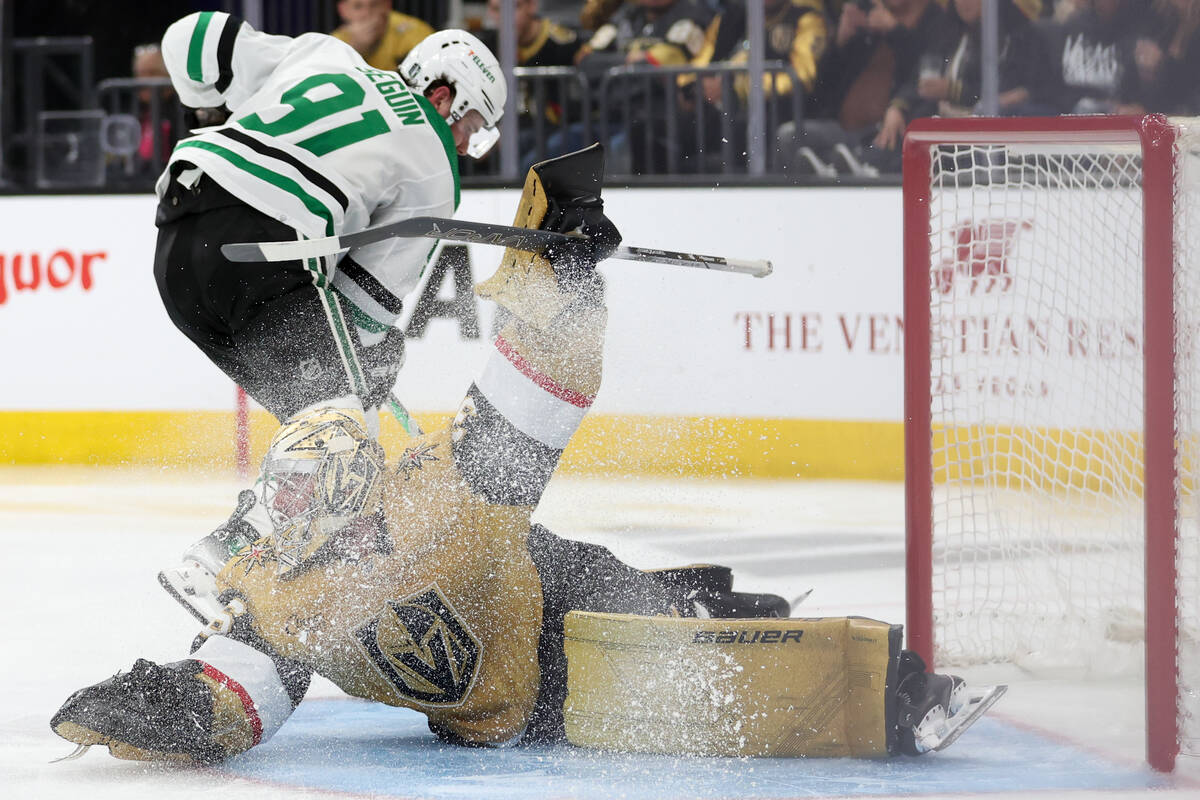 Golden Knights goaltender Logan Thompson (36) saves the puck while Stars center Tyler Seguin (9 ...