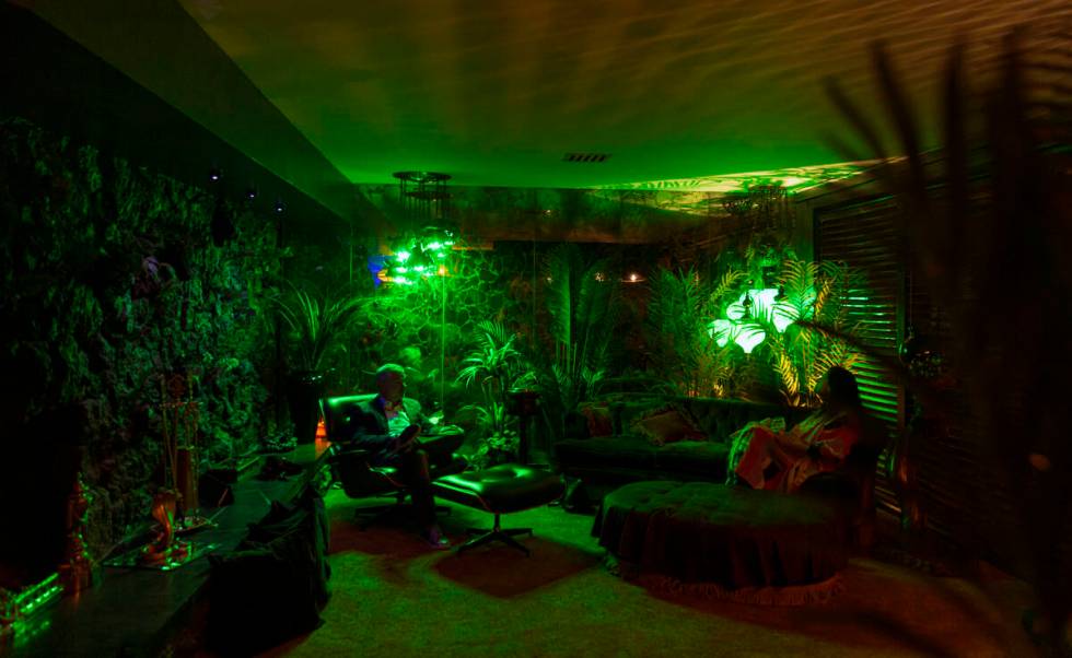 People relax during an evening party at a Beverly Green home called “Lava House” ...