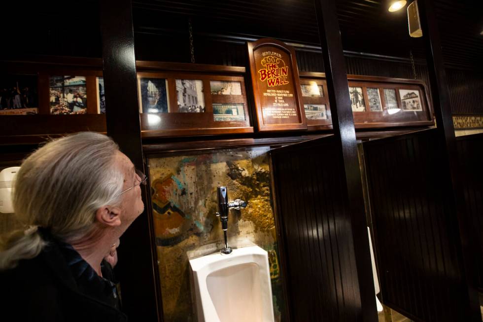 A piece of the Berlin Wall is seen in a men’s restroom at Main Street Station during a t ...