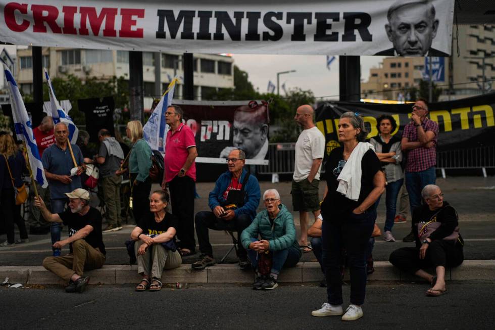 People protest against Israeli Prime Minister Benjamin Netanyahu's government in Tel Aviv, Isra ...