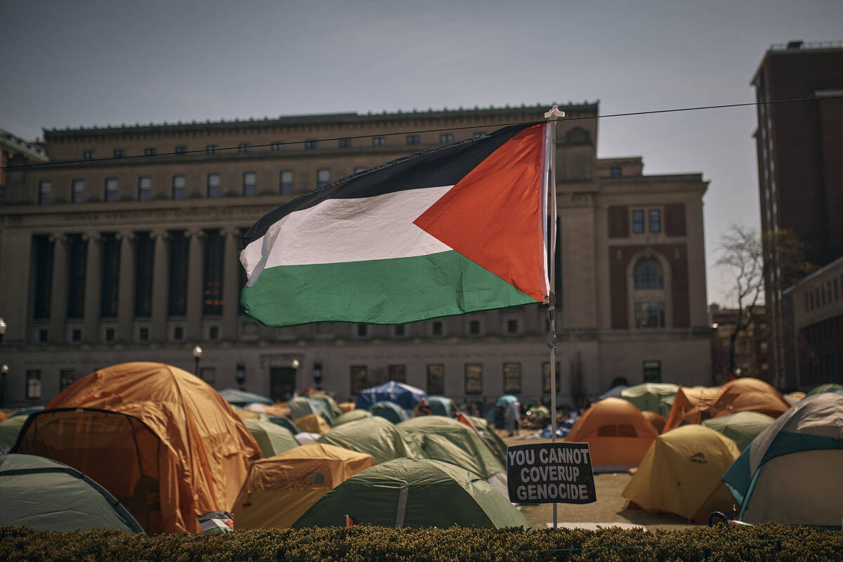 A Palestinian flag flutters in the wind during a pro-Palestinian encampment, advocating for fin ...