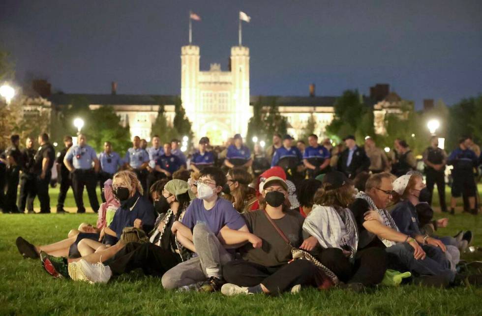 Protesters in support of Palestinians link arms as police prepare to arrest them on Washington ...